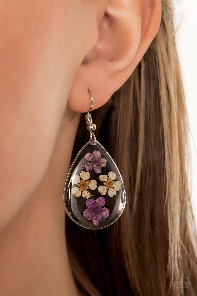 Dainty yellow and purple flowers are encased in a glassy teardrop, creating a whimsical frame. Earring attaches to a standard fishhook fitting.  Sold as one pair of earrings.