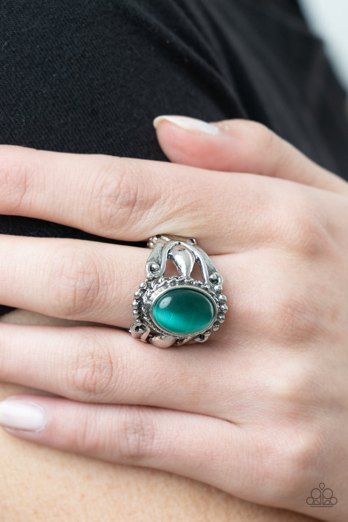 jubilant-gem-green A polished green cat's eye stone creates a jubilant statement as it rests inside a studded silver frame atop an airy pedestal like band. Features a stretchy band for a flexible fit.  Sold as one individual ring.