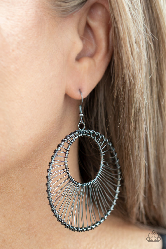 Glistening gunmetal wire wraps around two gunmetal hoops, creating an airy crescent shaped frame for an artisan inspired fashion. Earring attaches to a standard fishhook fitting.  Sold as one pair of earrings.