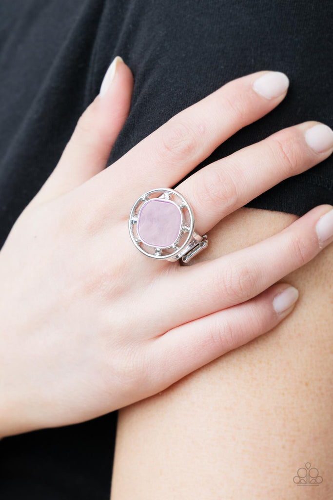 A pearly purple square bead, featuring rounded edges, is encircled with an airy silver compass-like frame creating a shimmering centerpiece atop the finger. Features a stretchy band for a flexible fit.  Sold as one individual ring.