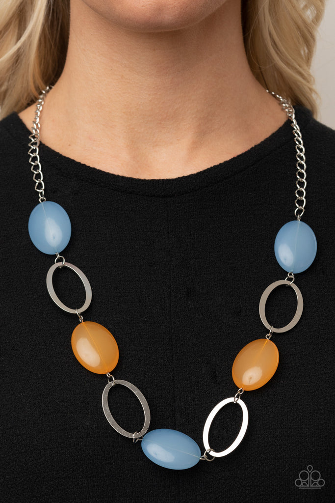 Shiny silver ovals and cloudy Cerulean and Marigold beads delicately link across the chest, creating a whimsical pop of color. Features an adjustable clasp closure.  Sold as one individual necklace. Includes one pair of matching earrings.