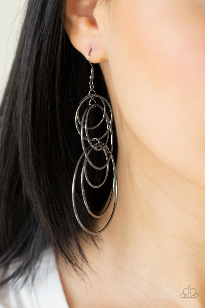 Varying in size, a shiny collection of mismatched gunmetal hoops haphazardly connect into a dizzying lure. Earring attaches to a standard fishhook fitting.  Sold as one pair of earrings.