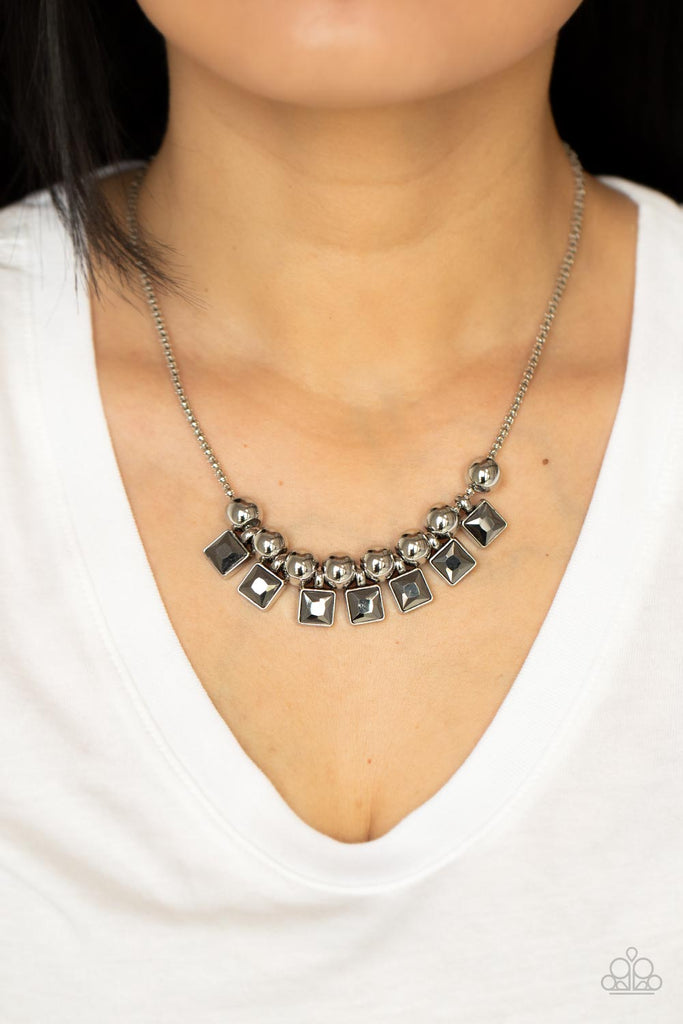 Smoky hematite square rhinestone frames and oversized silver beads alternate along a silver popcorn chain, creating a stellar fringe below the collar. Features an adjustable clasp closure.  Sold as one individual necklace. Includes one pair of matching earrings.