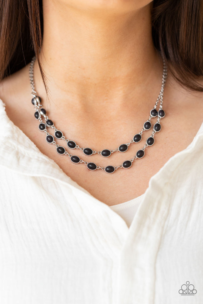 Encased in studded silver frames, two rows of oval black stones delicately connect below the collar for a seasonal flair. Features an adjustable clasp closure.  Sold as one individual necklace. Includes one pair of matching earrings.  