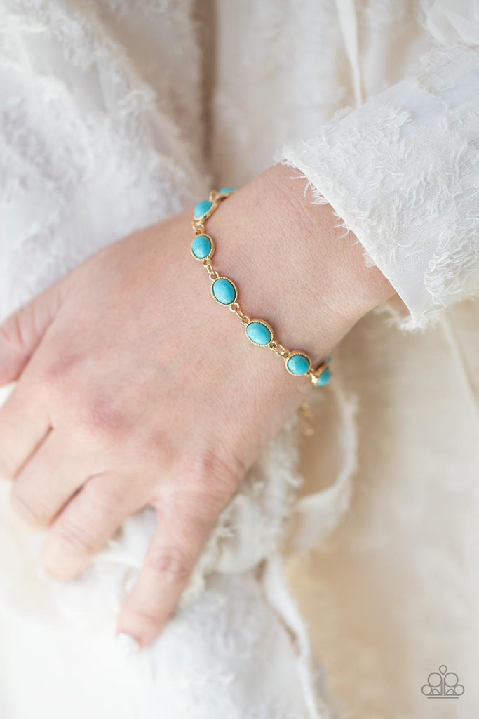 Encased in studded gold frames, oval turquoise stones delicately connect around the wrist for a seasonal flair. Features an adjustable clasp closure.  Sold as one individual bracelet.