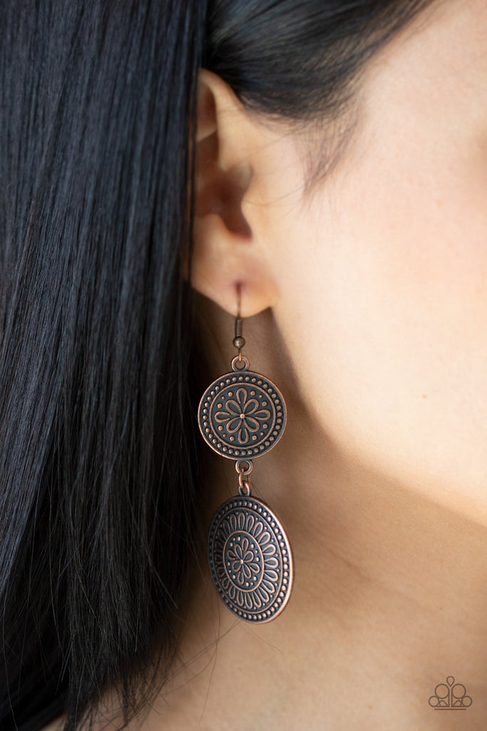 Embossed in floral filigree, two round copper frames delicately link into a rustic lure for a whimsy fashion. Earring attaches to a standard fishhook fitting.  Sold as one pair of earrings.