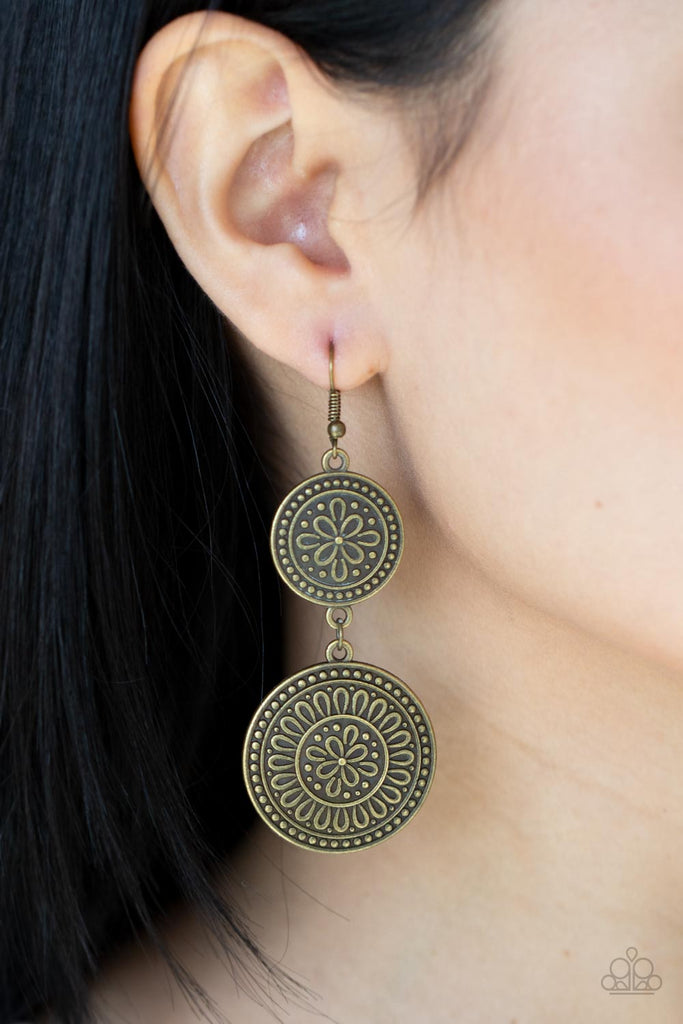 Embossed in floral filigree, two round brass frames delicately link into a rustic lure for a whimsy fashion. Earring attaches to a standard fishhook fitting.  Sold as one pair of earrings.