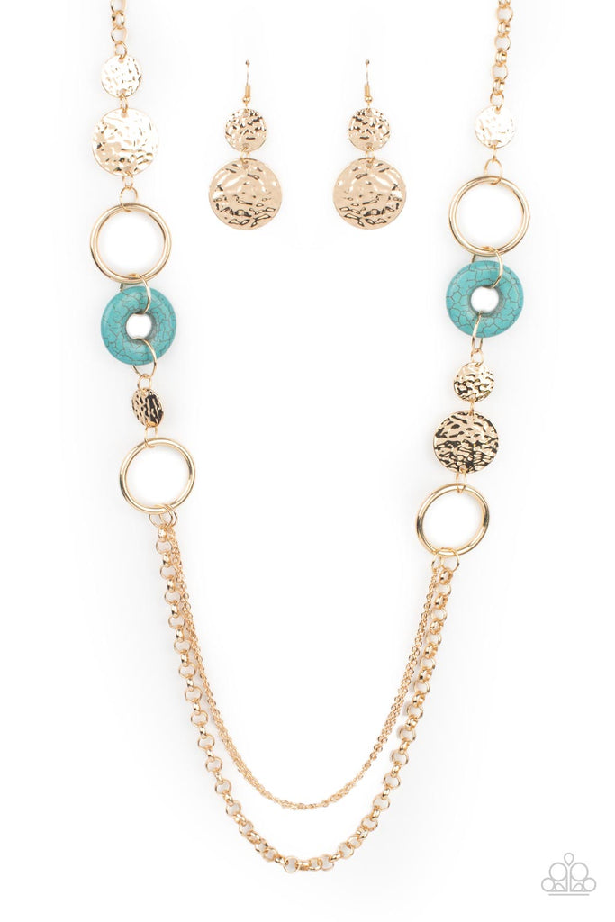 grounded-glamour-gold  An earthy collection of hammered gold discs, turquoise stone accents, and bold gold hoops link with sections of chunky and mismatched gold chains across the chest, creating a seasonal display. Features an adjustable clasp closure.  Sold as one individual necklace. Includes one pair of matching earrings.