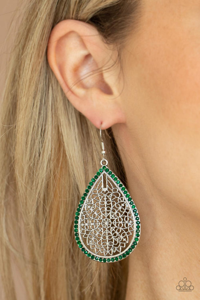 Bordered in dainty green rhinestones, the center of an oversized silver teardrop is filled with an airy floral pattern for a seasonal flair. Earring attaches to a standard fishhook fitting.  Sold as one pair of earrings.