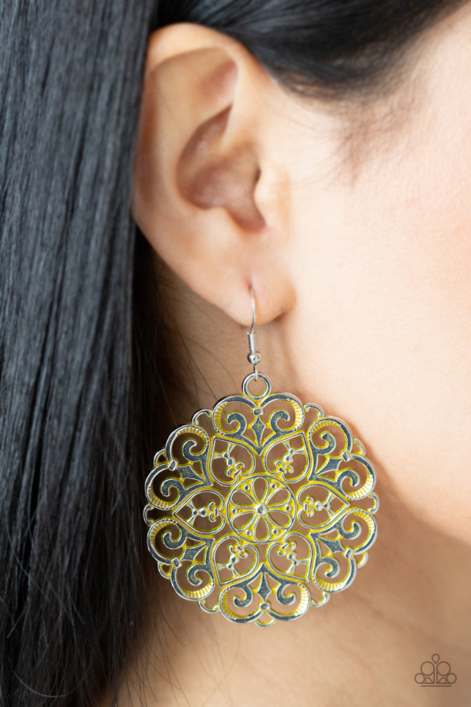 Brushed in a rustic yellow finish, an oversized mandala-like silver frame swings from the ear for a seasonal pop of color. Earring attaches to a standard fishhook fitting.  Sold as one pair of earrings.
