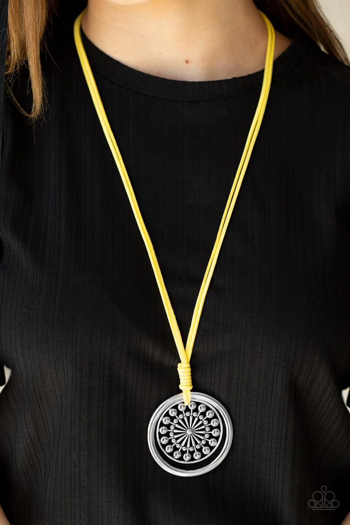 A lengthened piece of Illuminating suede cording is knotted around a silver ring and decorative studded silver frame, creating a whimsy mandala-like pendant. Features an adjustable clasp closure.  Sold as one individual necklace. Includes one pair of matching earrings.