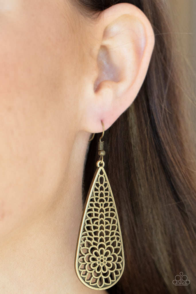 A mesmerizing explosion of antiqued brass filigree petals bursts inside an oversized teardrop frame creating a dreamy nature inspired lure. Earring attaches to a standard fishhook fitting.  Sold as one pair of earrings.