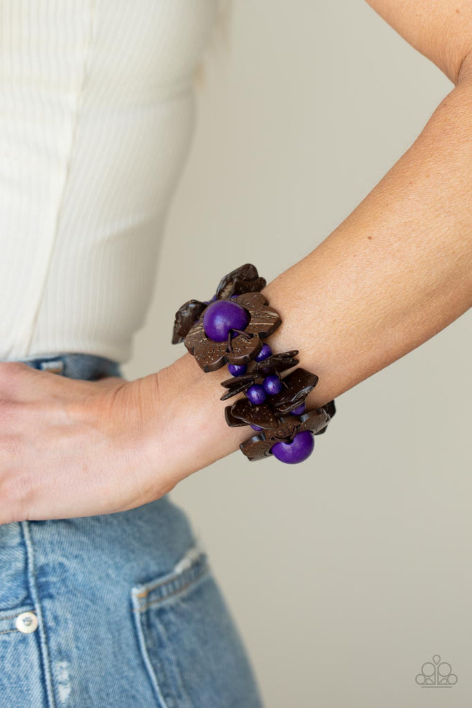 Distressed brown wooden pieces and round purple wooden beads join colorful wooden floral accents along stretchy bands around the wrist, creating a tropical inspired centerpiece.  Sold as one individual bracelet.