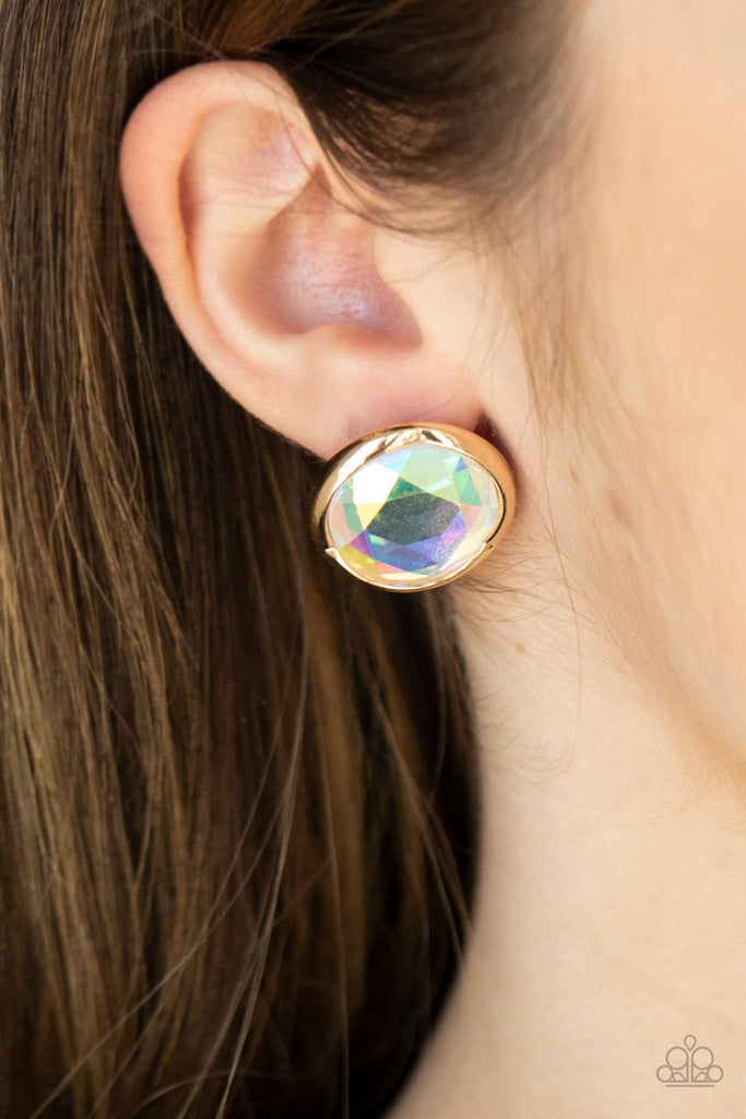 Featuring a flashy faceted finish, an oversized iridescent gem is pressed into a sleek gold fitting for a dramatic pop of dazzle. Earring attaches to a standard post fitting.  Sold as one pair of post earrings.