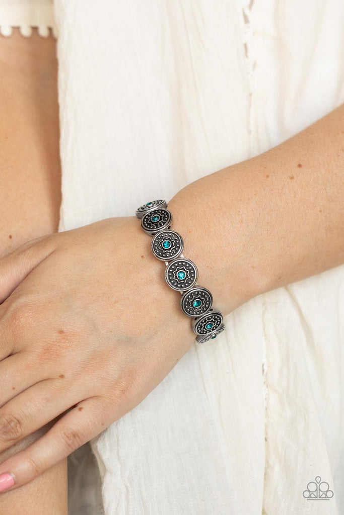 Dotted with glittery blue rhinestones, a collection of antiqued studded silver frames are embossed in star accents as they are threaded along stretchy bands around the wrist for a stellar fashion.  Sold as one individual bracelet.  New Kit