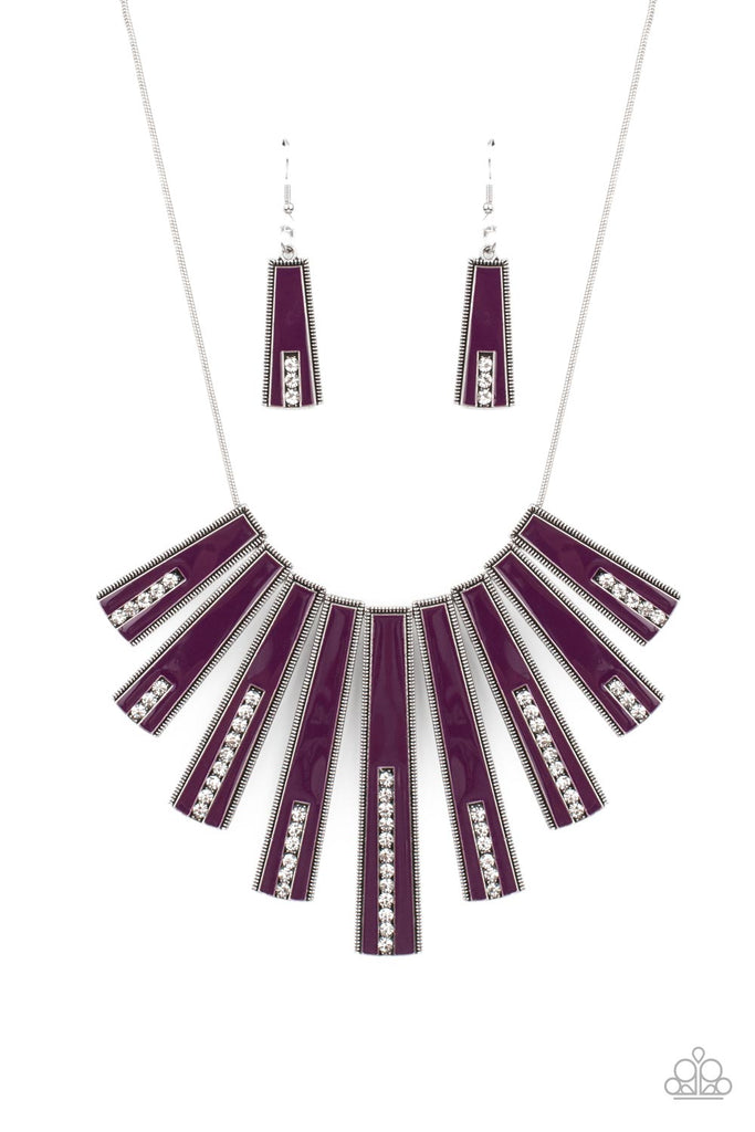 fan-tastically-deco-purple Encased in daintily dotted silver frames, a row of flared silver bars painted in a glossy purple, fans out across the collar. A column of sparkling white rhinestones rises from the bottom of each frame, creating a dramatically deco finish as they sway from a round silver chain. Features an adjustable clasp closure.  Sold as one individual necklace. Includes one pair of matching earrings.