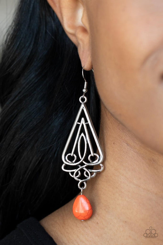 A refreshing orange teardrop stone swings from the bottom of an ornate triangular frame, creating a seasonal statement. Earring attaches to a standard fishhook fitting.  Sold as one pair of earrings.