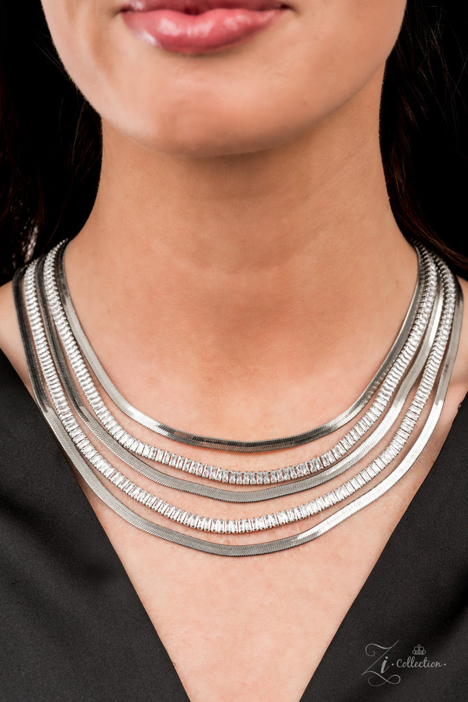 persuasive Alternating rows of flat silver snake chain and glassy strands of edgy emerald cut rhinestones sleekly layer below the collar. The deceptively simple metallic silver and white rhinestone palette is unapologetically mesmerizing, making this smooth statement piece an instant classic. Features an adjustable clasp closure.  Sold as one individual necklace. Includes one pair of matching earrings.