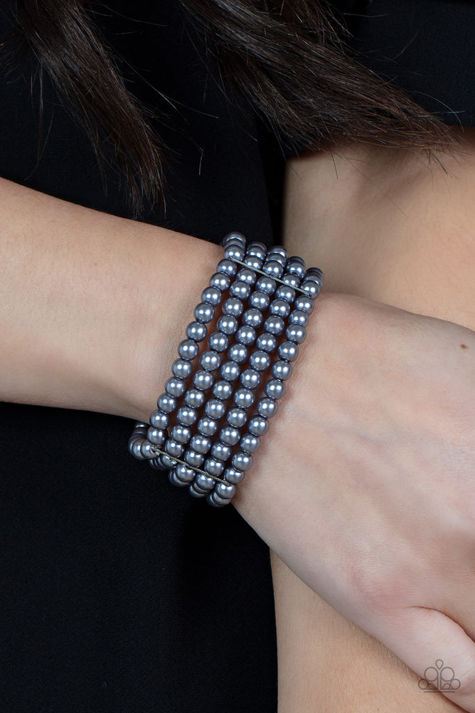 Stacked layers of luminous grey pearl-like beads are threaded along stretchy bands creating a subtly indulgent allure around the wrist.  Sold as one individual bracelet.  