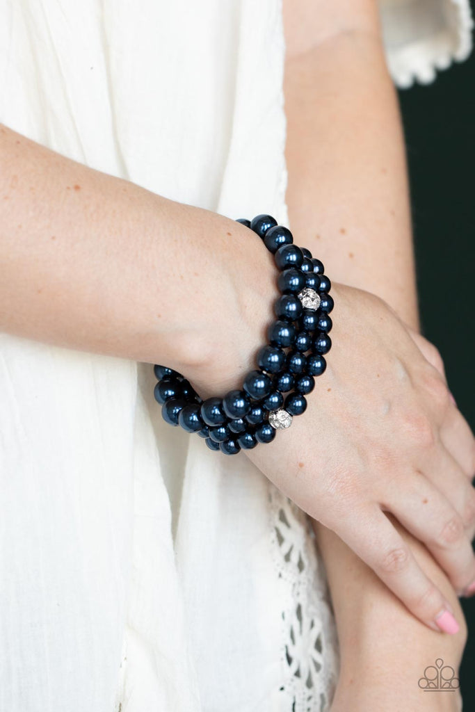 Infused with white rhinestone encrusted silver beads, a bubbly collection of mismatched blue pearls are threaded along stretchy bands around the wrist for a vintage inspired layered look.  Sold as one set of three bracelets.