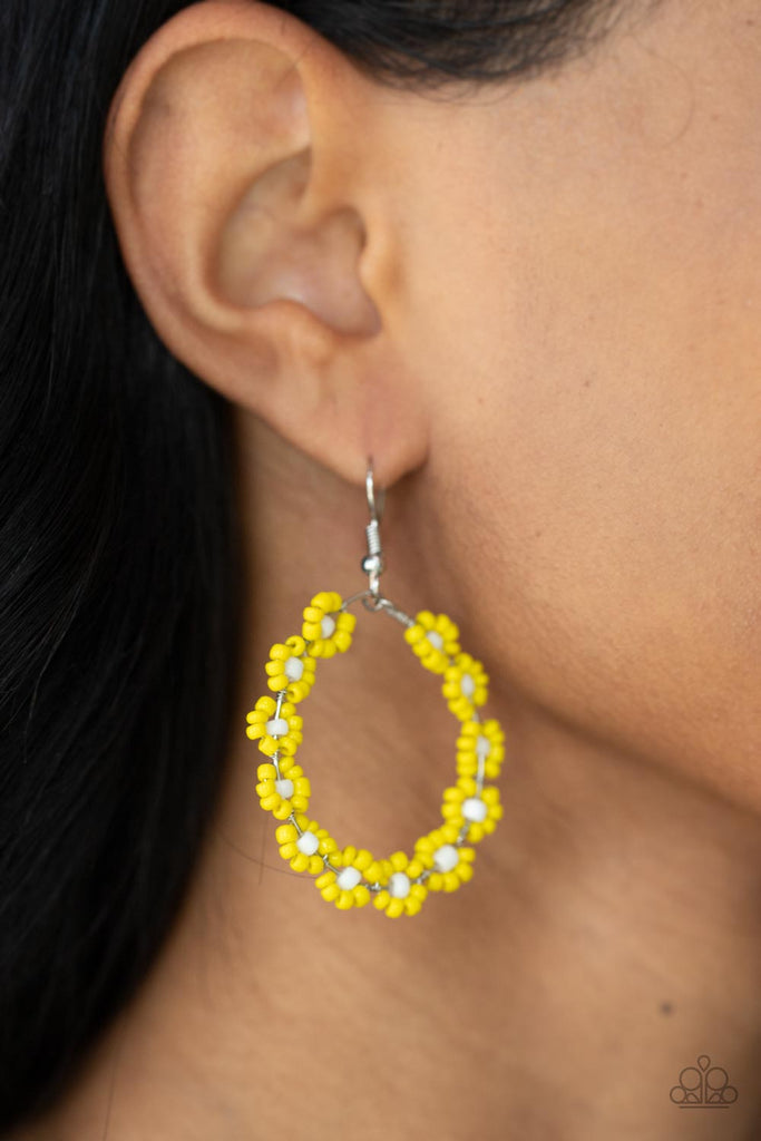 Dotted with white beaded centers, a dainty collection of Illuminating seed beaded floral frames are threaded along a wire hoop for a fabulous floral fashion. Earring attaches to a standard fishhook fitting.  Sold as one pair of earrings.