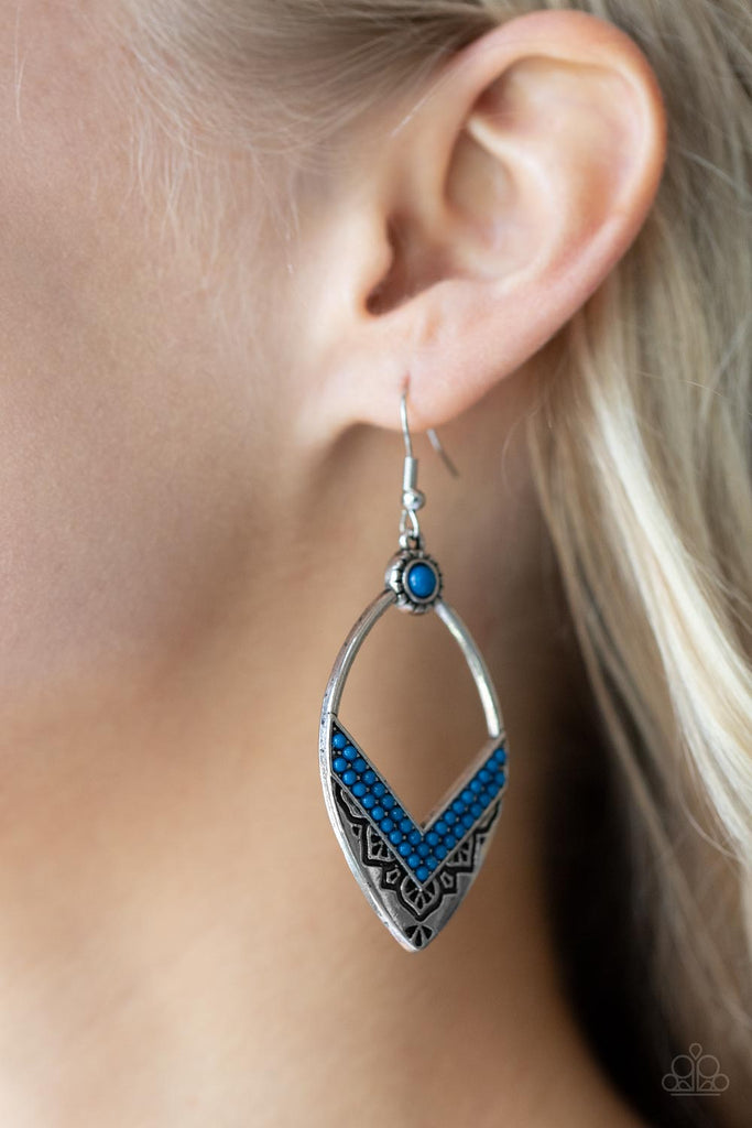 Two rows of Mykonos Blue seed beads create a V at the bottom of an airy silver frame embossed and stamped in indigenous inspired patterns. A matching Mykonos Blue seed bead adorns the top of the frame, adding additional color to the seasonal display. Earring attaches to a standard fishhook fitting.  Sold as one pair of earrings.