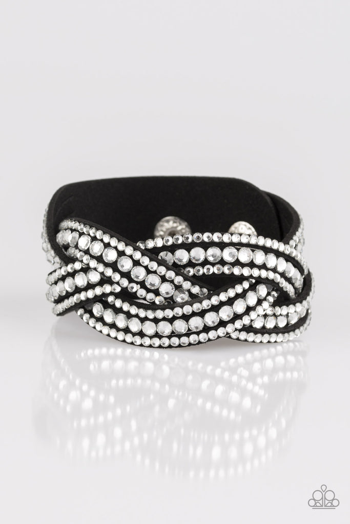 Varying in size, glassy white rhinestones are encrusted along interwoven black suede bands, creating blinding shimmer across the wrist. Features an adjustable snap closure.  Sold as one individual bracelet.