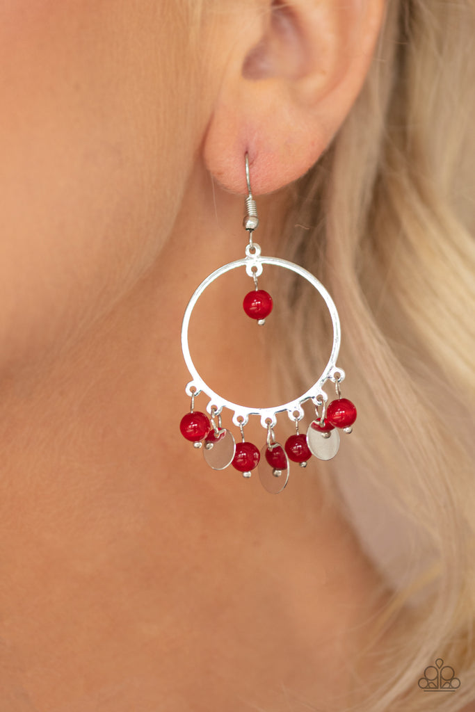 Dainty silver discs and glassy red beads swing from the bottom of a shimmery silver hoop, creating a colorful fringe. A solitaire red bead swings from the top of the hoop for a bubbly finish. Earring attaches to a standard fishhook fitting.  Sold as one pair of earrings.
