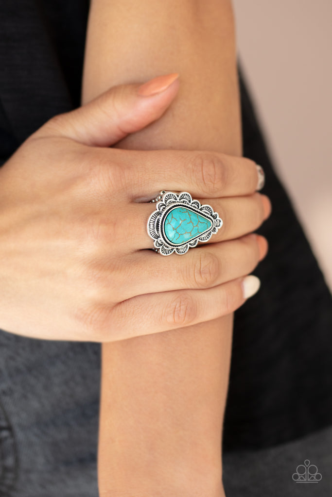 Chiseled into a tranquil teardrop, a refreshing turquoise stone is pressed into the center of a triangular silver frame bordered in a scalloped texture. Features a stretchy band for a flexible fit.  Sold as one individual ring.