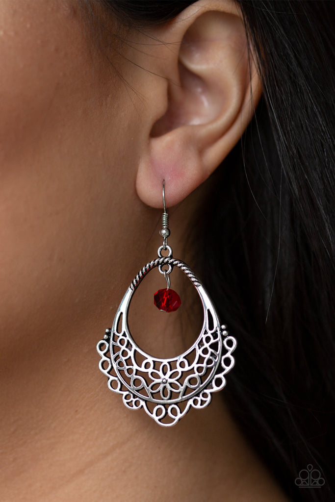 Glistening silver filigree swirls into a whimsical floral pattern on the bottom of an ornate teardrop frame. A red crystal-like bead swings from the top of the frame for a sparkling finish. Earring attaches to a standard fishhook fitting.  Sold as one pair of earrings.