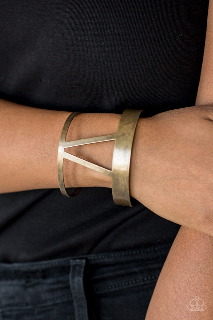 Brushed in an antiqued shimmer, an airy geometrical brass cuff wraps around the wrist for a tribal inspired look.  Sold as one individual bracelet.