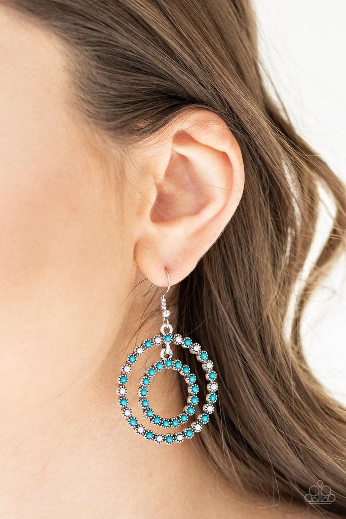 Dotted with dainty blue and gray beads, two studded silver hoops link together as they swing from the ear in a colorful fashion. Earring attaches to a standard fishhook fitting.  Sold as one pair of earrings.