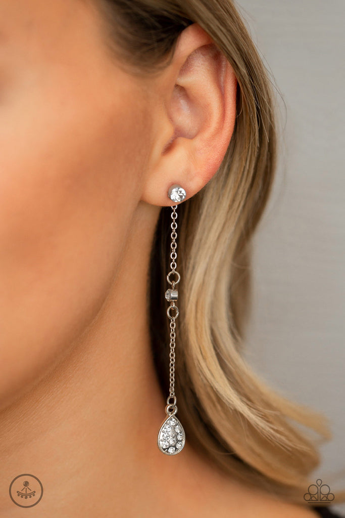 A solitaire white rhinestone fitting attaches to a double-sided post designed to fasten behind the ear. Dotted in dainty white rhinestones, a shimmery silver teardrop frame swings from the bottom of a shimmery silver chain peeking out behind the ear for an eye-catching finish. Earring attaches to a standard post fitting.  Sold as one pair of post earrings.