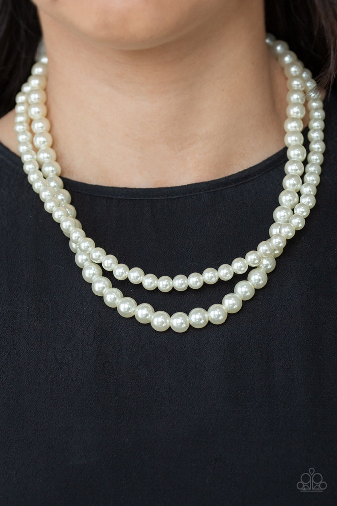Two strands of classic white pearls are strung along invisible wires below the collar. Each strand slightly varies in size, adding a modern twist to the timeless pearl palette. Features an adjustable clasp closure.  Sold as one individual necklace. Includes one pair of matching earrings.
