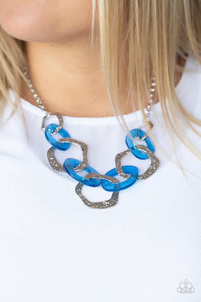 An asymmetrical assortment of neon blue acrylic rings and hammered silver hoops boldly interlock below the collar, creating an intense pop of color. Features an adjustable clasp closure.  Sold as one individual necklace. Includes one pair of matching earrings.  