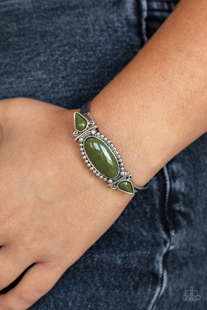 Infused with studded and filigree detail, two teardrop green beads flank an oversized oval green bead atop a dainty silver cuff for a colorful tribal inspired fashion.  Sold as one individual bracelet.