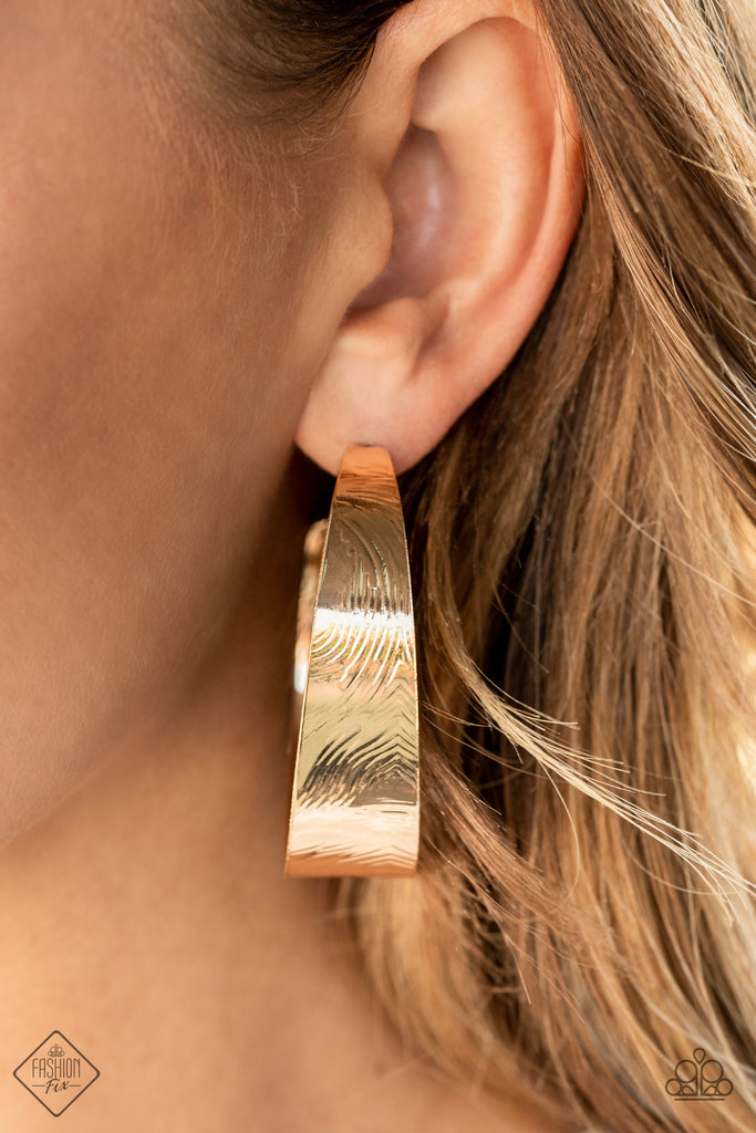 Embossed in whirling geometric details, a thick gold hoop boldly curls around the ear for a curvaceous look. Earring attaches to a standard post fitting. Hoop measures approximately 2" in diameter.  Sold as one pair of hoop earrings.  