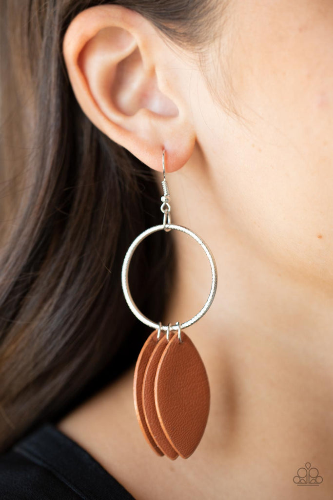 Leafy Adobe leather frames swing from the bottom of a textured silver hoop, creating an earthy fringe. Earring attaches to a standard fishhook fitting.  Sold as one pair of earrings.