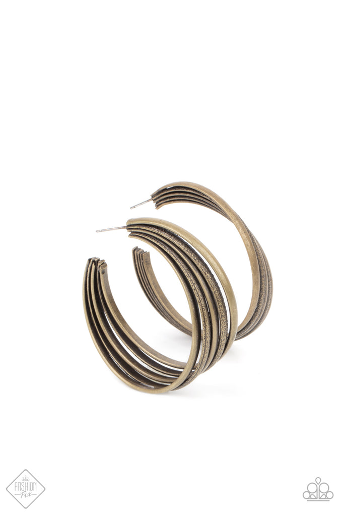 Textured brass rings merge with antiqued matte rings in a curvy ribbon of rustic drama as they wrap around behind the ear. Earring attaches to a standard post fitting. Hoop measures approximately 2" in diameter.  Sold as one pair of hoop earrings.