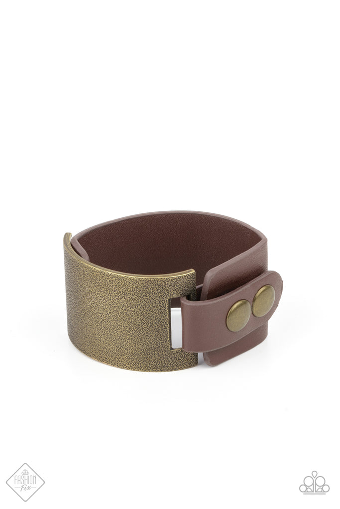 A curved brass panel, coated in antiqued texture, attaches to a wide brown leather band with brass snaps resulting in an edgy industrial element around the wrist. Features an adjustable snap closure.  Sold as one individual bracelet.