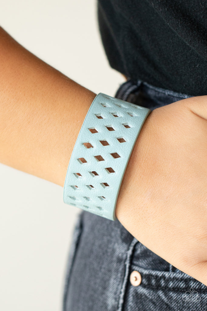glamp-champ-blue  A wide blue leather band is filled with patterned rows of small diamond-shaped cutouts giving the illusion of diamonds floating across the wrist in a whimsical fashion. Features an adjustable snap closure.  Sold as one individual bracelet.