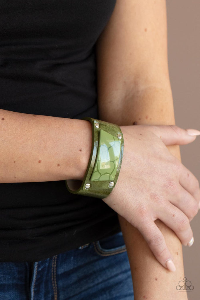 geo-glamper-green Featuring a faux marble finish, a green acrylic centerpiece attaches to an Olive Branch leather frame that is studded in place along a distressed Olive Branch leather band for a colorfully rustic fashion. Features an adjustable snap closure.  Sold as one individual bracelet.