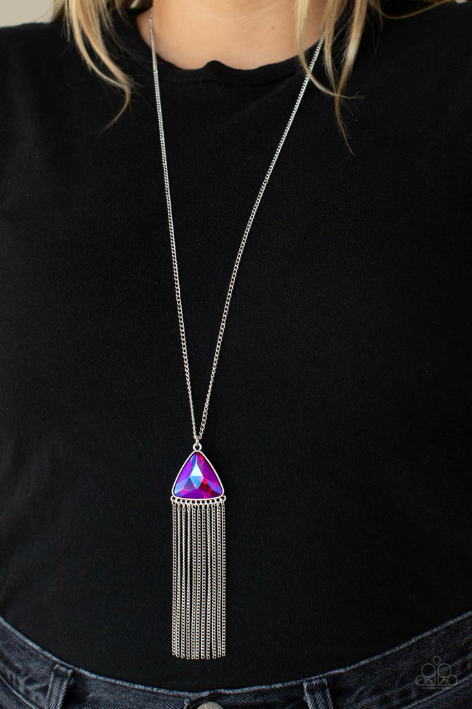 proudly-prismatic-pink Featuring a UV shimmer, an oversized pink triangular gem swings from the bottom of a lengthened silver chain. A curtain of silver chains streams out from the bottom of the sparkly pendant, adding playful movement to the glamorous statement piece. Features an adjustable clasp closure.  Sold as one individual necklace. Includes one pair of matching earrings.