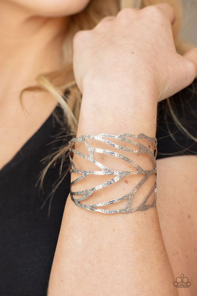 flock-stock-and-barrel-silver  Hammered in rustic details, an airy silver feather wraps around the wrist, creating a seasonal cuff.  Sold as one individual bracelet.