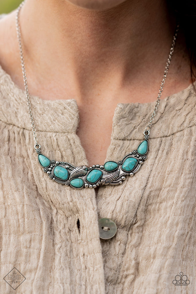 A collection of asymmetrical turquoise stones adorns the front of a studded silver frame embossed in floral and feathery accents. The pendant sits boldly below the collar, creating a seasonal centerpiece. Features an adjustable clasp closure.  Sold as one individual necklace. Includes one pair of matching earrings.