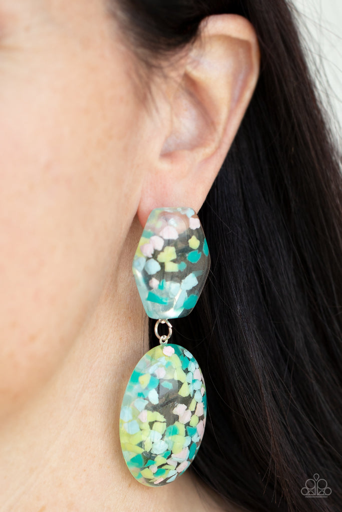 Featuring multicolored confetti-like flakes, a clear acrylic oval frame swings from the bottom of a matching hexagonal frame, creating a bubbly lure. Earring attaches to a standard post fitting.  Sold as one pair of post earrings.