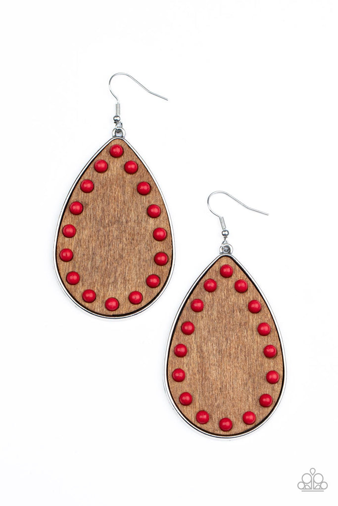 rustic-refuge-red Dainty red stone beads border an earthy wooden teardrop frame that is encased in a sleek silver fitting, creating a whimsical woodsy lure. Earring attaches to a standard fishhook fitting.  Sold as one pair of earrings.   