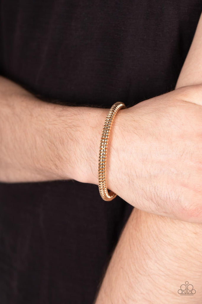 A glistening gold cable has been wrapped tightly around a gold cuff, creating edgy shimmer around the wrist.  Sold as one individual bracelet.