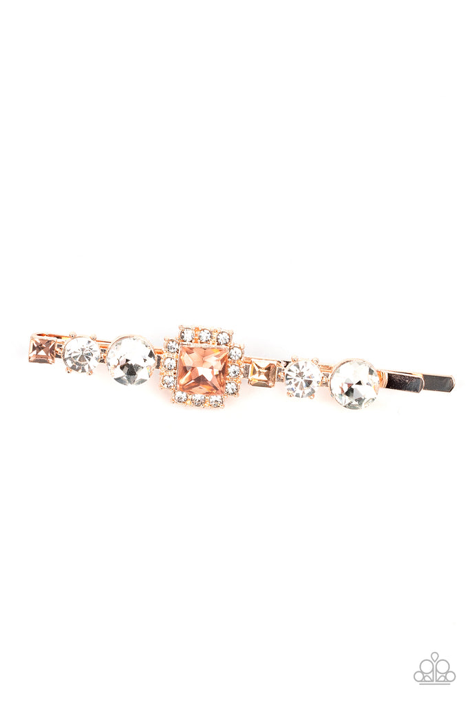 Featuring a brilliant radiant cut peach gem surrounded by a frame of dainty white rhinestones, a mismatched collection of white round and square peach rhinestones coalesce into a stunning display.  Sold as one individual hair clip.
