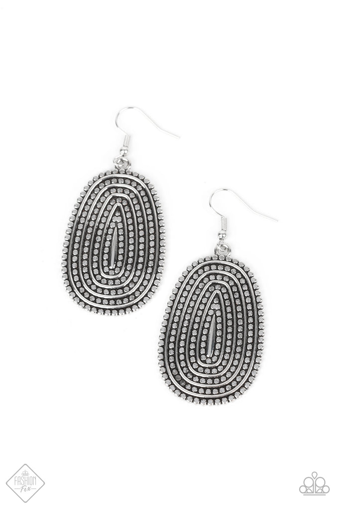 Rows of antiqued silver dotted texture radiate outward from an embossed center. The concentric lines create a rippling effect across the frame resulting in a rustic finish. Earring attaches to a standard fishhook fitting.  Sold as one pair of earrings.